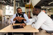 © VICTOR TORRES/Stocksy - African American Businessmen Engaging in Serious Discussion