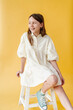 © Melissa Milis Photography/Stocksy - Girl wearing sneakers and white dress