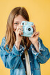 © Melissa Milis Photography/Stocksy - Pre teen girl taking a picture