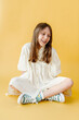 © Melissa Milis Photography/Stocksy - Quiet, shy tween girl sitting portrait