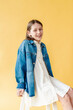 © Melissa Milis Photography/Stocksy - Preadolescent girl wearing jean jacket studio portrait