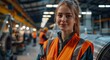 © Georgii - Confident female engineer in a high-visibility vest at a modern industrial manufacturing facility