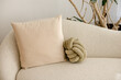 © Leah Flores/Stocksy - Closeup of Couch and Pillow in Neutral Tones