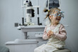 © Iuliia Versta/Stocksy - Little girl checking up her sight at ophthalmology center