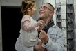 © Iuliia Versta/Stocksy - Father and daughter in an optician shop
