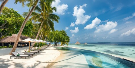 Wall Mural - A stunning view of the pool and beach at an island resort in Maldives, with palm trees swaying gently under blue skies  The swimming area is surrounded by lush greenery Generative AI