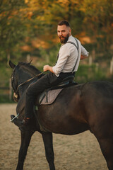 Wall Mural - Rear view of cowboy horseback riding and looking over his shoulder.