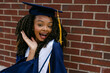 © Lea Jones/Stocksy - portrait of smiling college graduate