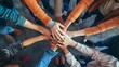 © Yeivaz - Diverse group of people joining hands together in a circle showing teamwork and unity