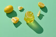 © Marc Tran/Stocksy - Lemons and lemonade isolated on bright light green background