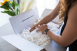 © Raul Navarro/Stocksy - Close-up of hands exploring biodegradable packing peanuts in a box