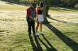 © Lea Jones/Stocksy - young couple  playing golf in the morning sun