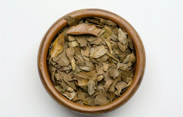 Sticker - Mate tea leaves in brown ceramic bowl on white background Close up photo from above