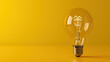 © otter2 - a light bulb, leaning slightly to the left, on a vivid yellow background