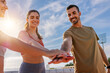 © Xavier Lorenzo - Young group of sportive friends stacking hands before workout routine. Sports team and fitness motivation concept.