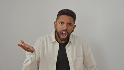 Wall Mural - Young african american man, standing in surprise and disbelief, wearing a shirt, with open mouth, amazed and scared, over isolated white background