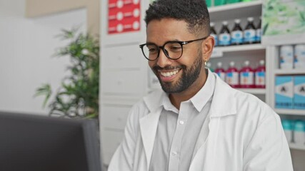 Wall Mural - Young african american pharmacist, a embodiment of success and victory in pharmacy, exultant with raised arms over the computer