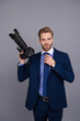 © be free - Photo journalist man or paparazzi photographer taking picture with professional camera isolated on grey