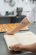 © Raul Navarro/Stocksy - Professional pastry chef preparing baking sheet in kitchen