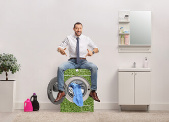 Wall Mural - Businessman in a bathroom sitting on top of efficient washing machine