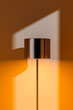 © Marcos Osorio/Stocksy - Shadow of modern lamp on warm interior wall