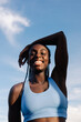 © Adrian Rodd/Stocksy - Portrait of a happy empowered Aforo-European fitness woman