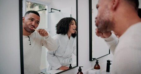 Canvas Print - Dental, toothbrush and man brushing teeth in bathroom for oral hygiene, wellness or morning routine. Mirror, cleaning and couple with reflection for fresh breath, healthy mouth or natural grooming