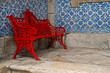 © Tessy Morelli/Stocksy - Typical Portuguese red bench with Azulejos