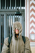 © Mal de Ojo Studio/Stocksy - Playful Hooded Person in Urban Setting
