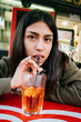 © Mal de Ojo Studio/Stocksy - Young Woman Enjoying Drink in CafÃ©