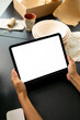 © Artem Podrez/Stocksy - Hands Holding Tablet Mockup with Blank Screen in Creative Workspace