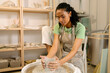 © Artem Podrez/Stocksy - Woman Entrepreneur Creating Pottery at Ceramic Studio