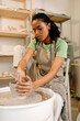 © Artem Podrez/Stocksy - Woman Artist Creating Pottery in Creative Studio