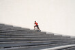 © Hernandez & Sorokina/Stocksy - Athlete Running Up The Stairs At White Wall Background