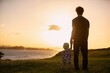© Kathrine Schleicher/Stocksy - Father and Child Watching Sunset in San Juan