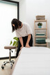 © Álvaro Lavín/Stocksy - Woman preparing massage table.