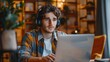 © hisilly - Online Support Service: Call Center Operators Communicating with Clients via Headsets at Work; Serious Man Wearing Hands-Free Headset Using Laptop