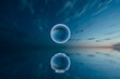 © Marcos Osorio/Stocksy - Floating sphere in water with sky background