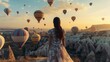 © Marco - beautiful woman from behind in a big dress in cappadocia with balloons flying