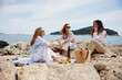 © Boris Jovanovic/Stocksy - Women enjoy together on a beach picnic