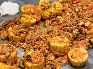 Close-up of homemade seafood dish consisting of green mussels, squid, prawns and corn. Cooked with special seasoning recipe and has sour, spicy, sweet, savory taste and is best eaten with rice.