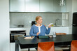 © DZ FILM/Stocksy - A woman controls the air conditioner using a remote control