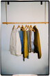 © Adrian Rodd/Stocksy - Small minimalist coat rack hanging from the ceiling with jackets