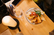 © Mal de Ojo Studio/Stocksy - Gourmet Meal on Wooden Table