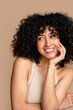 © mahalo studio/Stocksy - Radiant smile - woman with curly hair