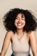 © mahalo studio/Stocksy - woman with curly hair smiling