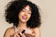 © mahalo studio/Stocksy - Woman enjoying fragrance from perfume bottle
