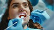 © Farid - Young beautiful woman having her teeth examined during dental appointment at dentist's office.