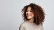 © CStock - Smiling woman with curly hair in casual outfit,