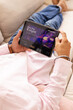 © Wavebreak Media - Watching movie on tablet, man relaxing on couch at home